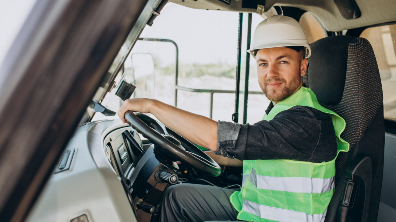 Male worker with bulldozer in sand quarry