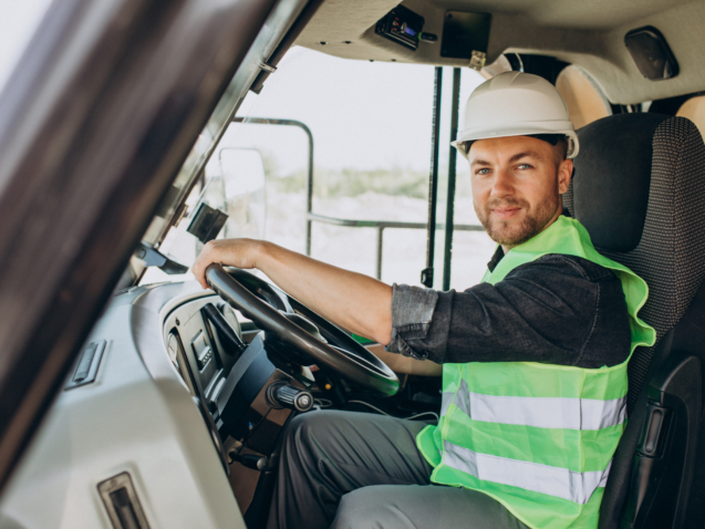 Male worker with bulldozer in sand quarry